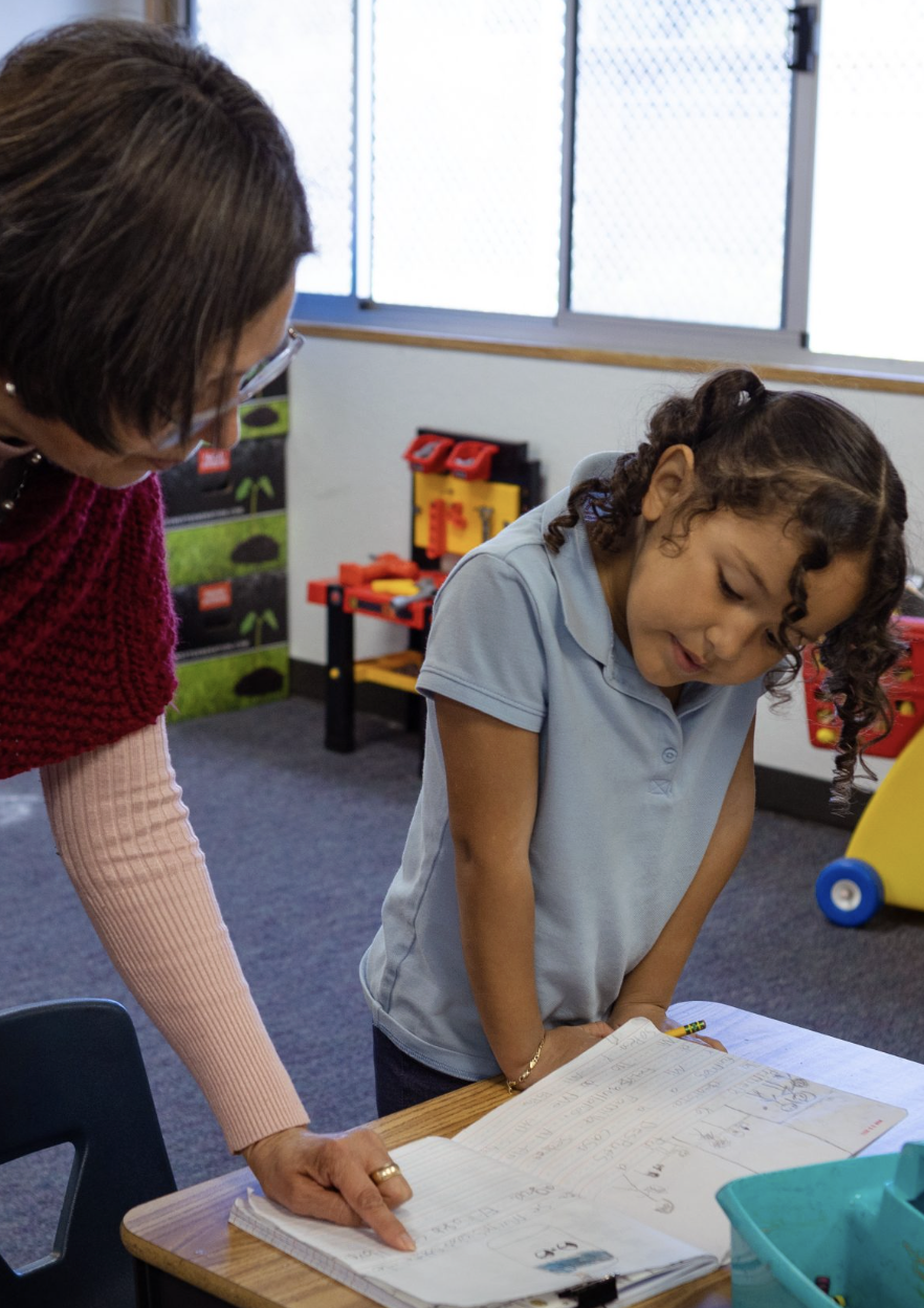 Student working on white board<br />
